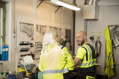 Male and female colleagues working in workshop