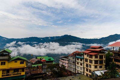 High angle view of buildings and mountains against sky