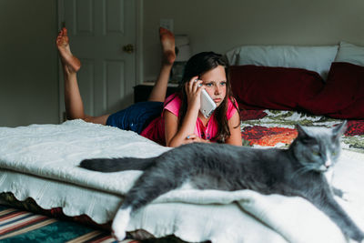 Portrait of woman lying on bed at home