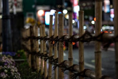 Close-up of metal fence at night