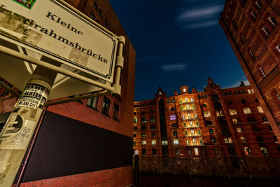 Low angle view of illuminated building against sky at night