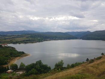 Scenic view of lake and mountains against sky