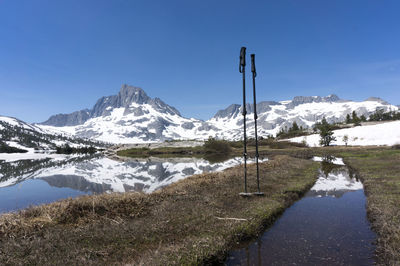 Scenic view of snowcapped mountains against clear blue sky