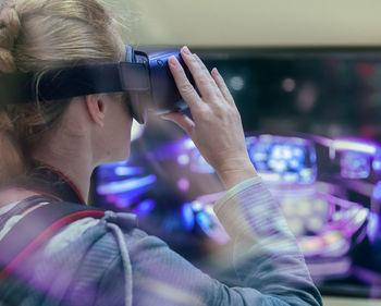 Mid adult woman using virtual reality at home