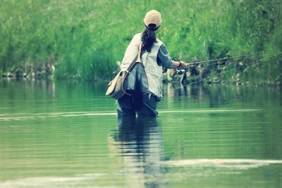 Reflection of woman in lake