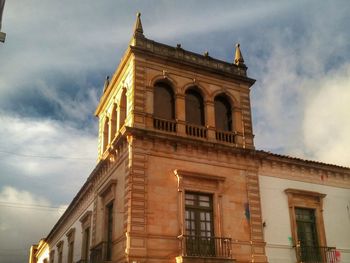 Low angle view of building against cloudy sky