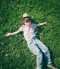 Full length of woman with arms raised on field