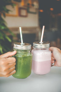 Cropped hand holding drink