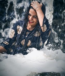 Portrait of a smiling young woman in sea