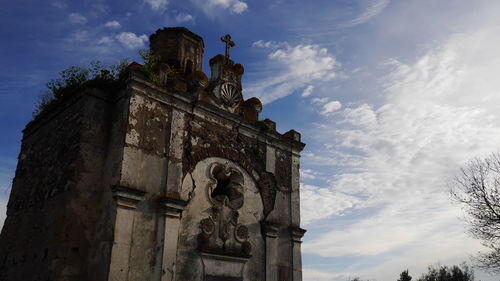Low angle view of historical building against cloudy sky