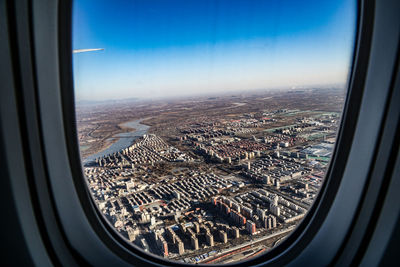 Aerial view of city seen through airplane window