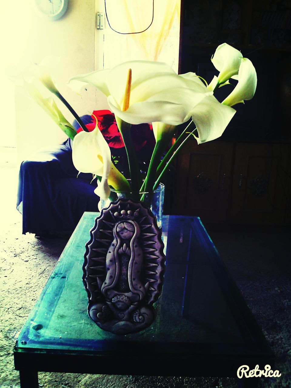 flower, indoors, close-up, communication, still life, no people, high angle view, table, day, plant, text, white color, fragility, western script, human representation, petal, yellow, freshness, wall - building feature, focus on foreground