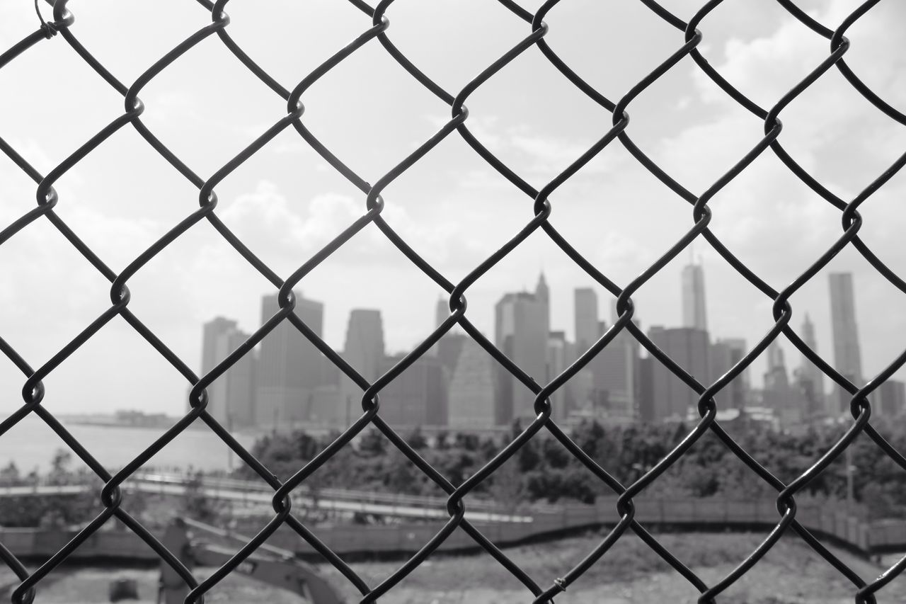 chainlink fence, protection, fence, safety, security, metal, full frame, focus on foreground, city, water, backgrounds, sky, pattern, day, sea, cityscape, outdoors, no people, built structure, building exterior