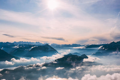 Aerial view of snowcapped mountains against sky