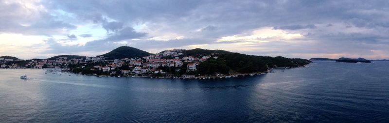 Panoramic shot of town by sea against sky