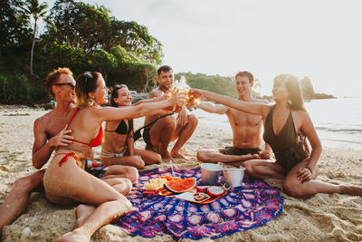 Friends enjoying at beach during summer