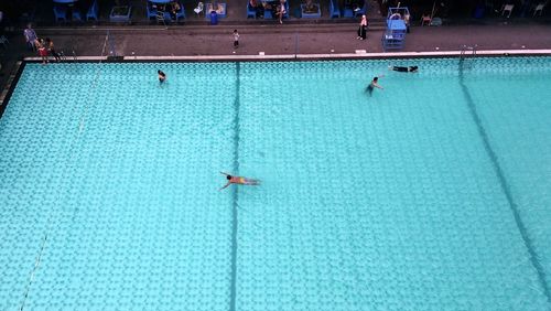 High angle view of people enjoying at swimming pool
