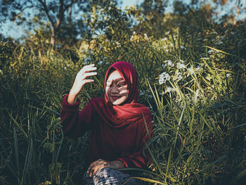 Portrait of smiling young woman on field