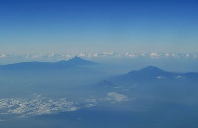 Scenic view of mountains against blue sky