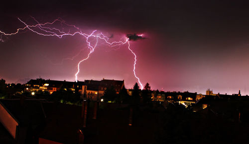 Storm clouds over city at night