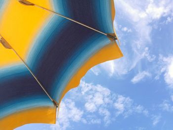 Low angle view of multi colored umbrella against sky