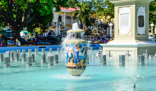 Woman by swimming pool in city