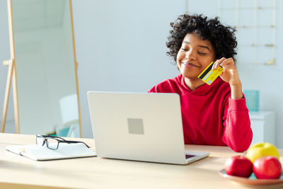 Young woman using laptop on table