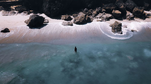 Aerial view of woman standing on beach