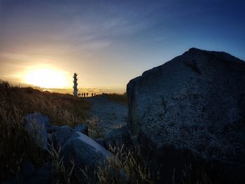 Silhouette lighthouse against sky during sunset