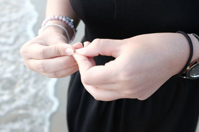 Midsection of woman holding hands