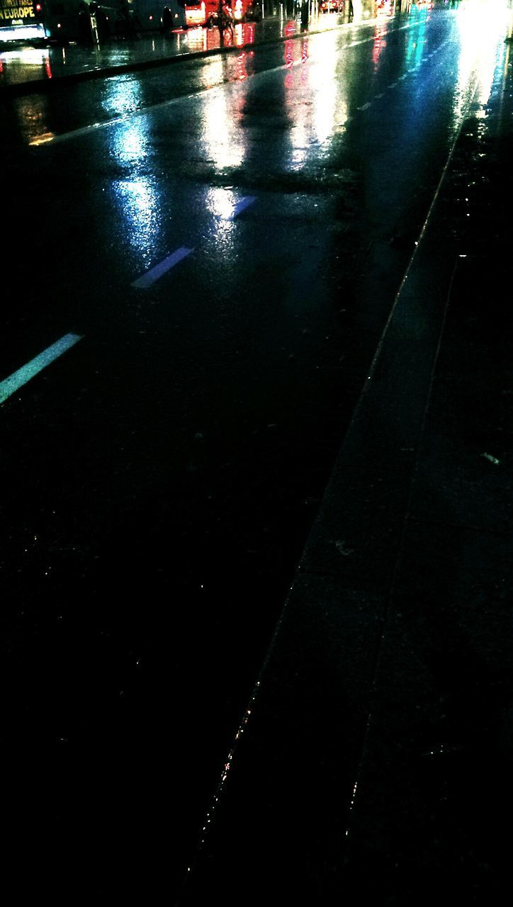 transportation, street, mode of transport, car, wet, road, reflection, night, high angle view, water, land vehicle, rain, road marking, puddle, asphalt, city, no people, outdoors, illuminated, weather