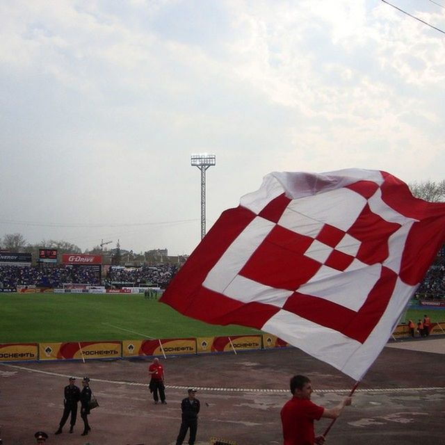 patriotism, flag, sky, leisure activity, lifestyles, national flag, red, person, men, identity, american flag, large group of people, cloud - sky, umbrella, day, outdoors, cloud, walking, city