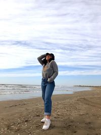 Full length of man standing at beach against sky