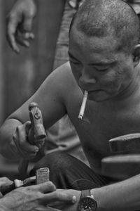 Rear view of a man smoking cigarette