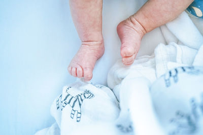 High angle view of baby lying on crib