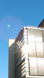 Low angle view of buildings against clear blue sky