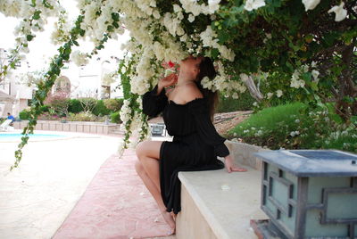 Young woman sitting outdoors