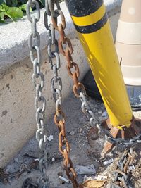 High angle view of metal chain on rope