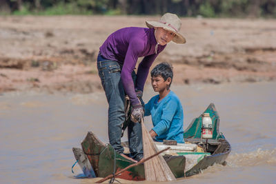 Man with umbrella on shore