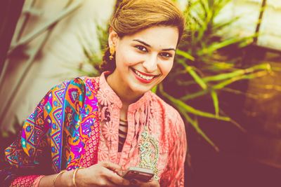 Portrait of happy beautiful woman using phone