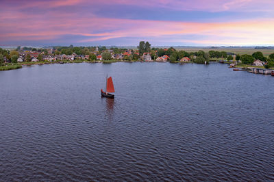 Aerial from the village oudega in the netherlands at sunset