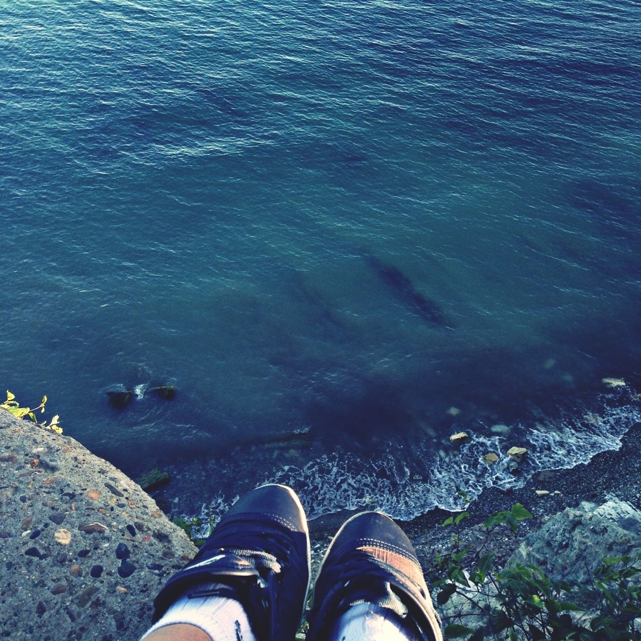 low section, person, personal perspective, shoe, water, human foot, high angle view, standing, footwear, men, unrecognizable person, lifestyles, leisure activity, part of, rock - object, nature, lake