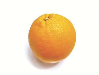 Close-up of orange apple against white background