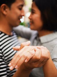 Midsection of couple holding hands