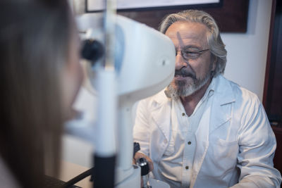 Young woman doing eye test at the optometrist's