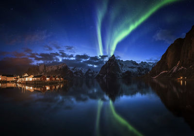 Panoramic view of illuminated mountains against sky at night