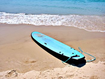 High angle view of surf board on beach