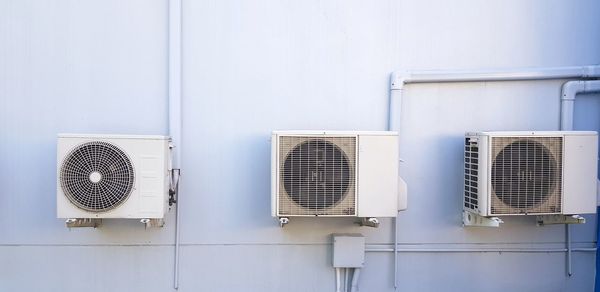 White image of electric fan on wall