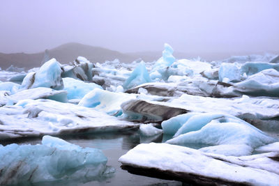 Scenic view of frozen lake against sky