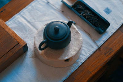 High angle view of teapot on table